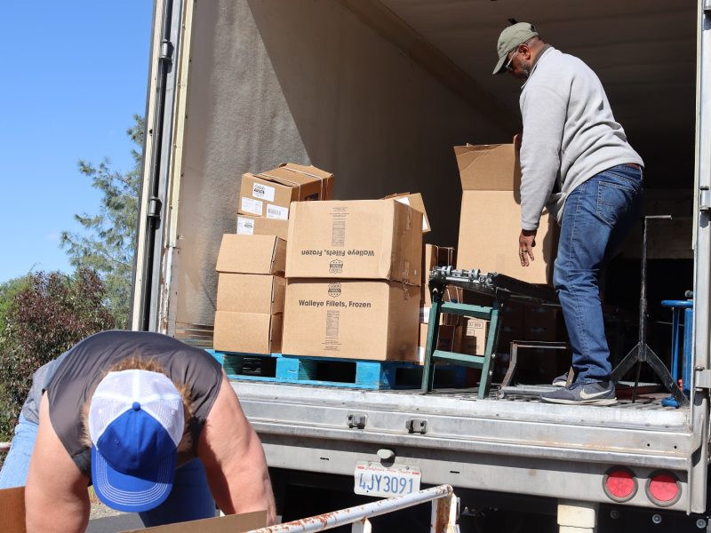 Already into the distribution tribal staff seen loading cart as Specialist Ronald Buckman readies another box from the pallets. Ronald Buckman and Tiger Paulk unloading goods for the California Valley Miwok Tribe
