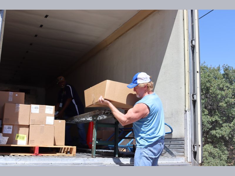 Tule River Food Specialist, "Ronald Buckman" loads conveyor as tribal staff load the last of one recipients distribution. California Valley Miwok Tribe's Tiger Paulk loading food supplies on a conveyor