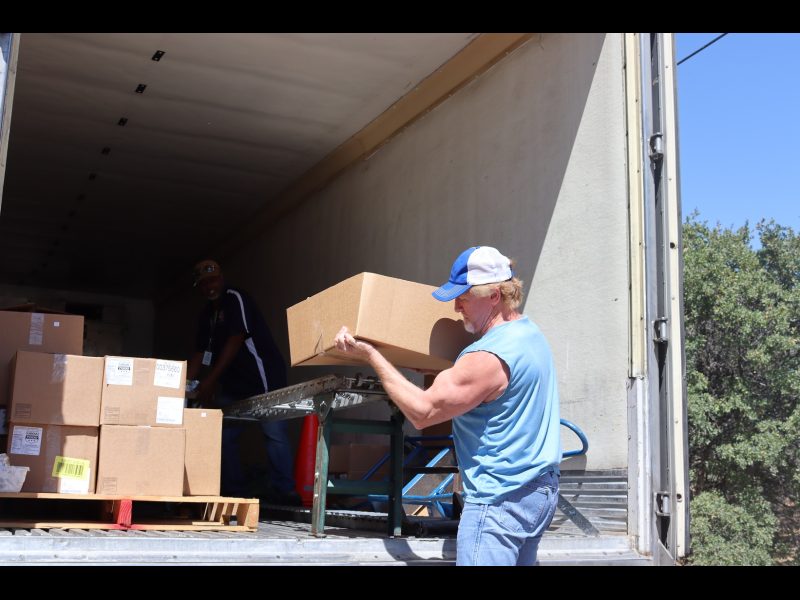 Tule River Food Specialist, "Ronald Buckman" loads conveyor as tribal staff load the last of one recipients distribution. California Valley Miwok Tribe's Tiger Paulk loading food supplies on a conveyor