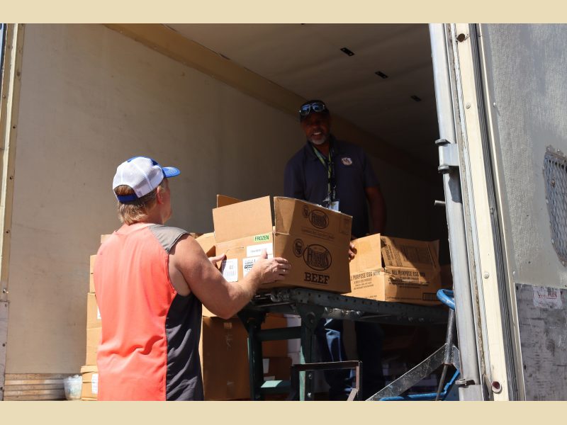 California Valley Miwok Tribe staff member Tiger Paulk is helping Ronald Buckman to unload good supplies.