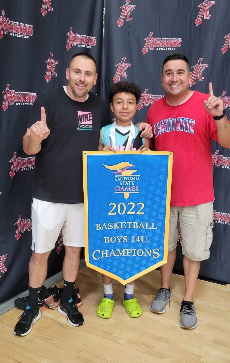 Duron Buckman with his coaches after winning the 2022 basketball boys 14U California state championship