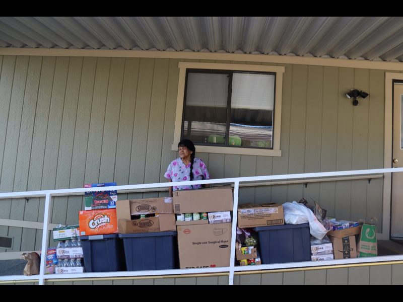 Program Director Mildred Burley just after producing video stands with distribution. California Valley Miwok Tribe elder Mildred Burley received food delivery.