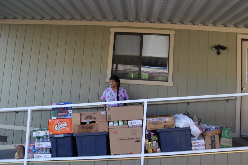 Program Director Mildred Burley just after producing video stands with distribution. California Valley Miwok Tribe elder Mildred Burley received food delivery.