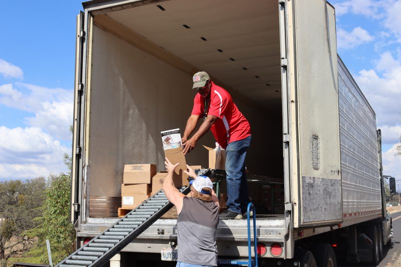 Specialist Ronald Buckman assists tribal staff with product for one of the day's recipients. Ronald Buckman and Tiger Paulk are unloading goods for the California Valley Miwok Tribe.