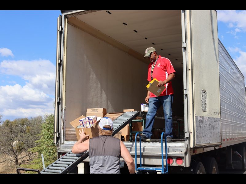 Staffer collecting the last of a distribution, while Ronald Buckman with clipboard and paperwork readies to get signature of new recipient. Ronald Buckman readies to get signature of new recipient for the California Valley Miwok Tribe.