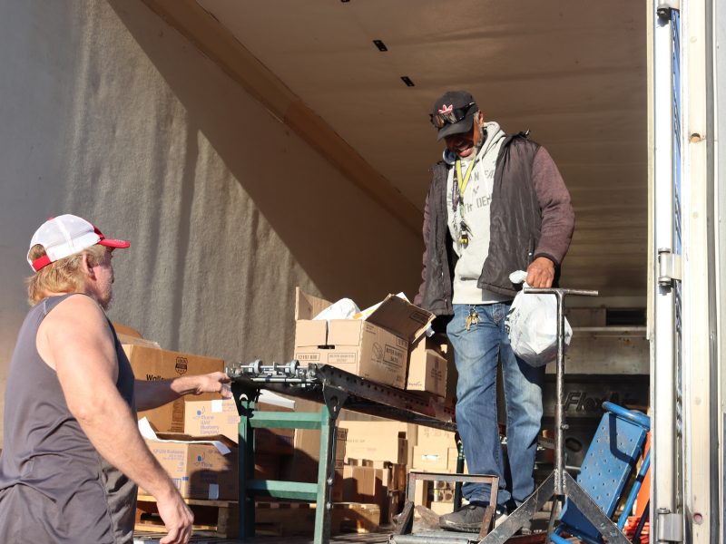Another moment further into the days distribution unloading pictured Ronald Buckman and tribal staff. Ronald Buckman is helping Tiger Paulk to unload devliery goods for the California Valley Miwok Tribe.