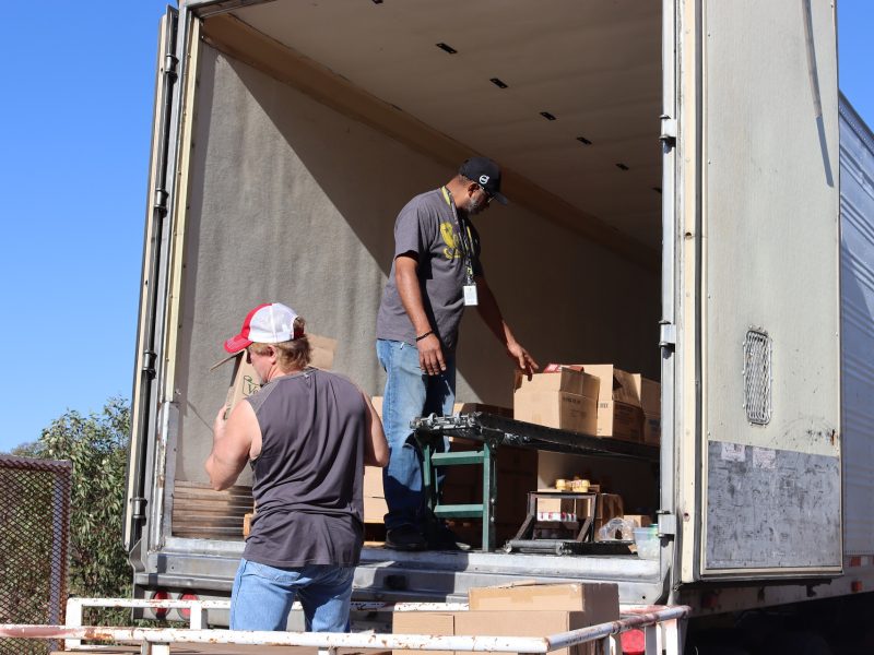 During the October distribution, the conveyor looks pretty full as with the economy in shambles real people's nutritional needs are left unmet, necessitating a real humanitarian need for programs such as this and their expansion. Tiger Paulk and Ronald Buckman unloading goods for the California Valley Miwok Tribe