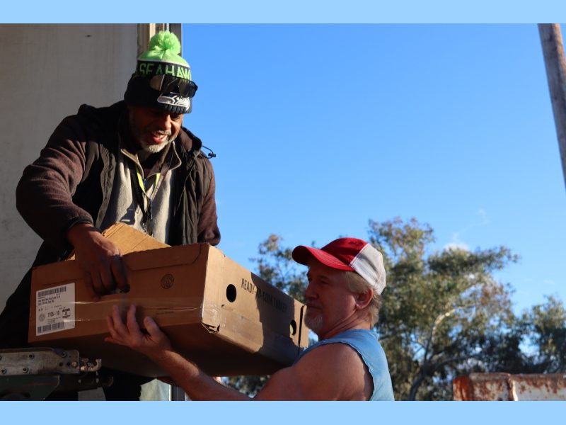 Ronald helping Tiger unloading the good supplies for the California Valley Miwok Tribe.
