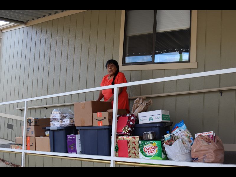 Director Mildred Burley pictured with December distribution. Mildred Burley with December 2022 food distribution.