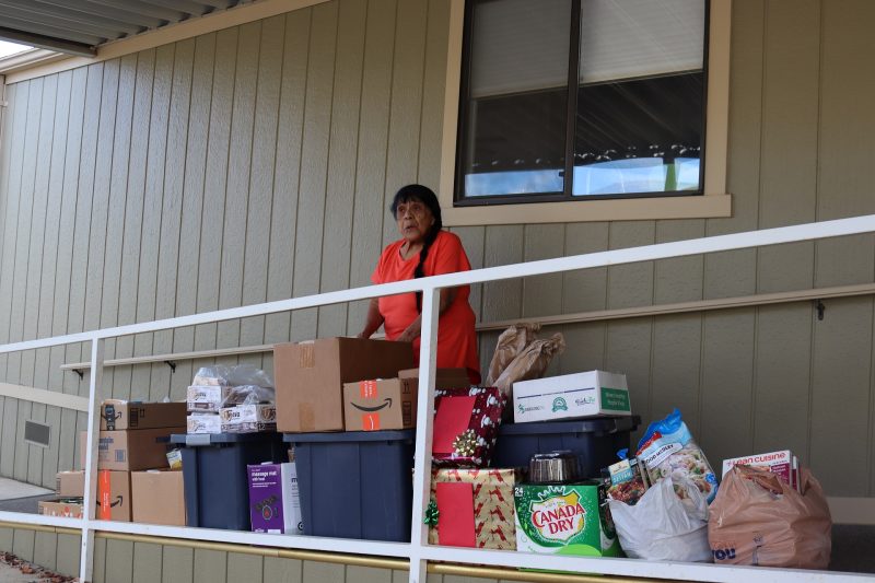 Director Mildred Burley pictured with December distribution. Mildred Burley with December 2022 food distribution.