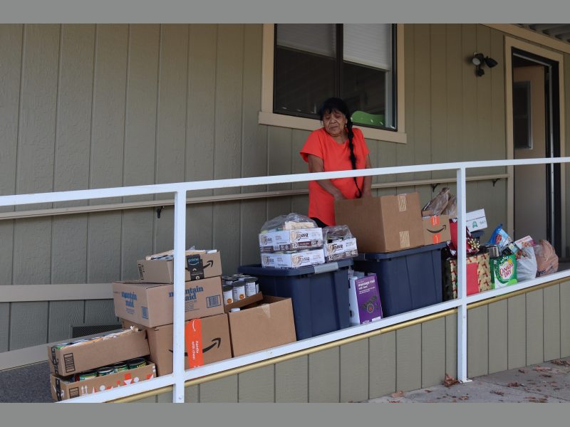 Mildred Burley and December 2022 goods from the Food For Tribal Families Program.