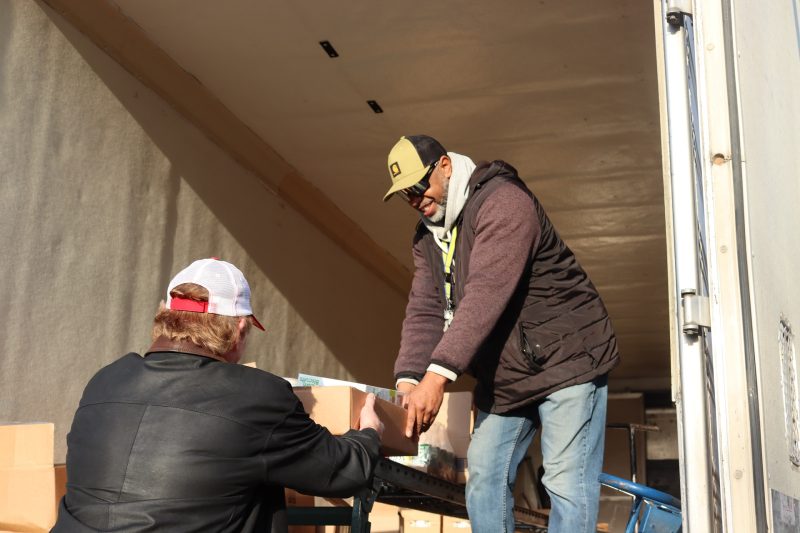Last distribution of the day as Ronald Buckman assists tribal staff. Ronald Buckman assists tribal staff unloading goods.