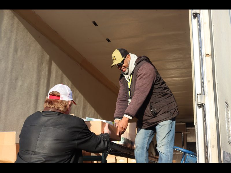 Last distribution of the day as Ronald Buckman assists tribal staff. Ronald Buckman assists tribal staff unloading goods.