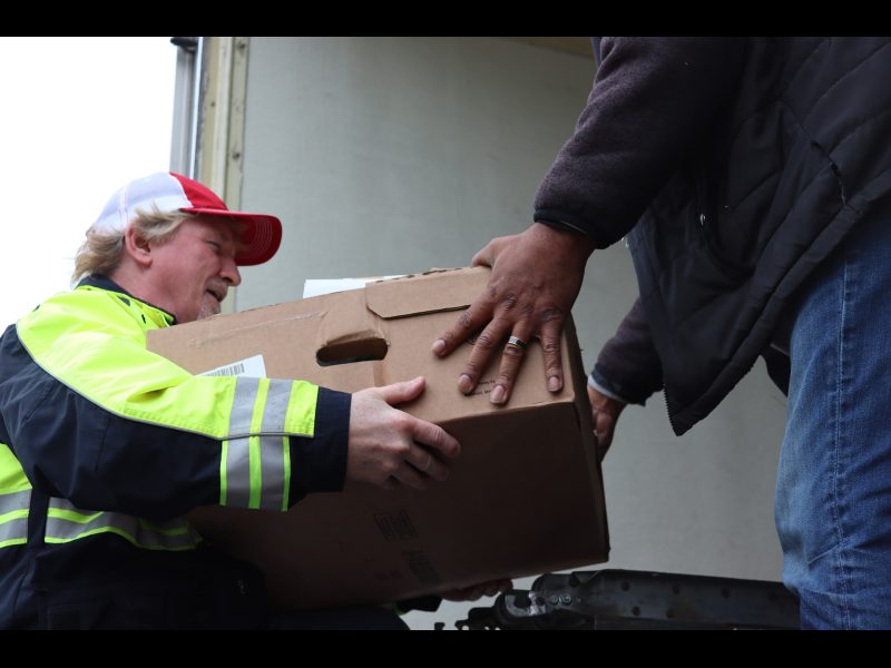 During a very short break in the weather food was unloaded as rapidly
as possible. California Valley Miwok Tribal staff unloading goods.