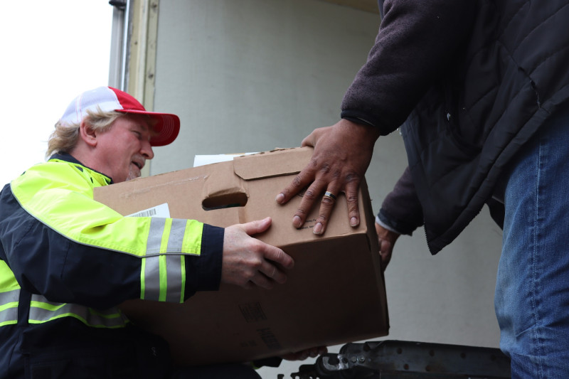 During a very short break in the weather food was unloaded as rapidly
as possible. California Valley Miwok Tribal staff unloading goods.