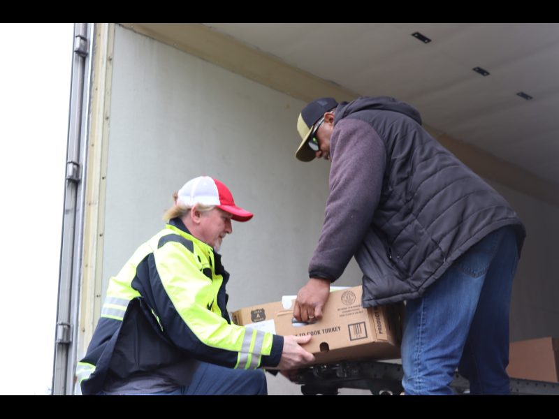 Tribal staff and specialist Ronald Buckman unloading one of the more heavy laden boxes. Tribal staff Tiger and Ronald unloading heavy boxes for the Miwok tribes.