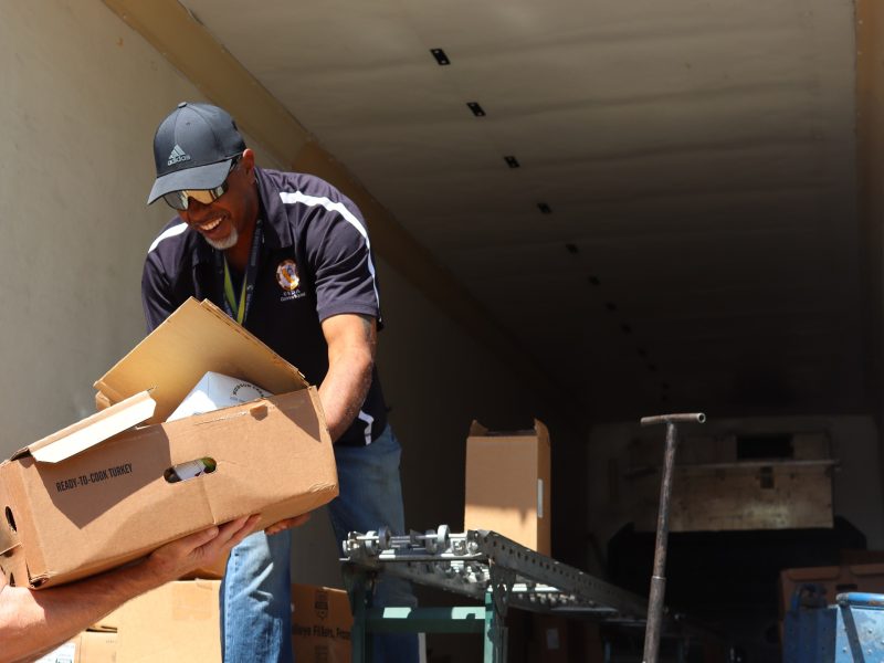 Ronald Buckman and staff having a good time during the transfer of one very heavy box.