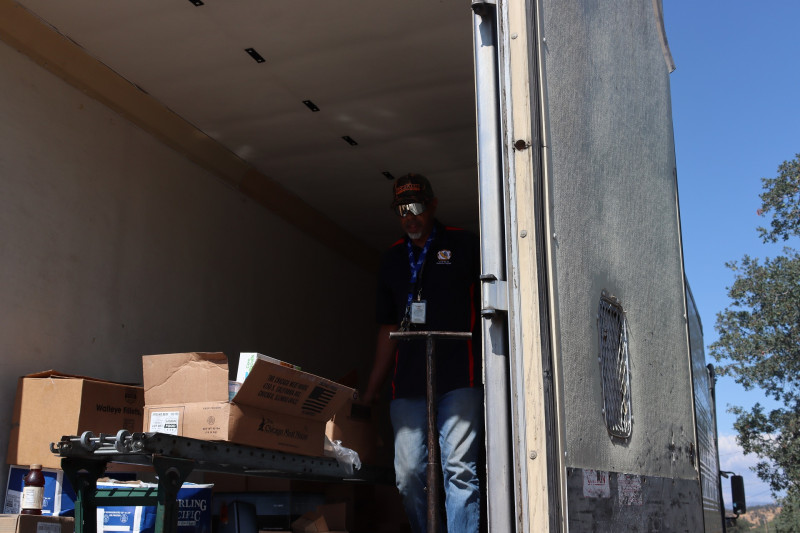 Here specialist Ronald Buckman is rolling out another distribution, looking just too cool. Tiger and Ronald Buckman unloading a truck of goods for Miwok tribal members.