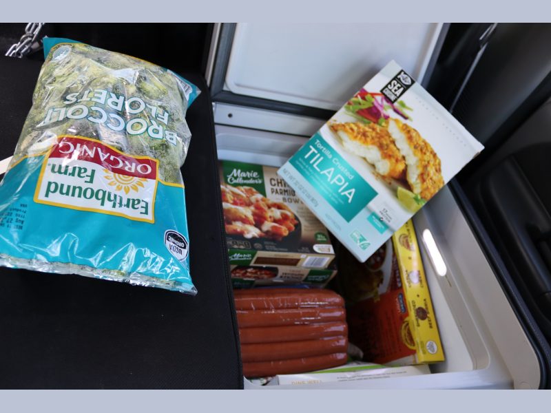Additional freezer compartment filled to the top with various frozen items. Frozen foods for the Miwok Tribe.
