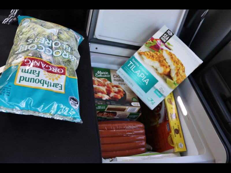 Additional freezer compartment filled to the top with various frozen items. Frozen foods for the Miwok Tribe.
