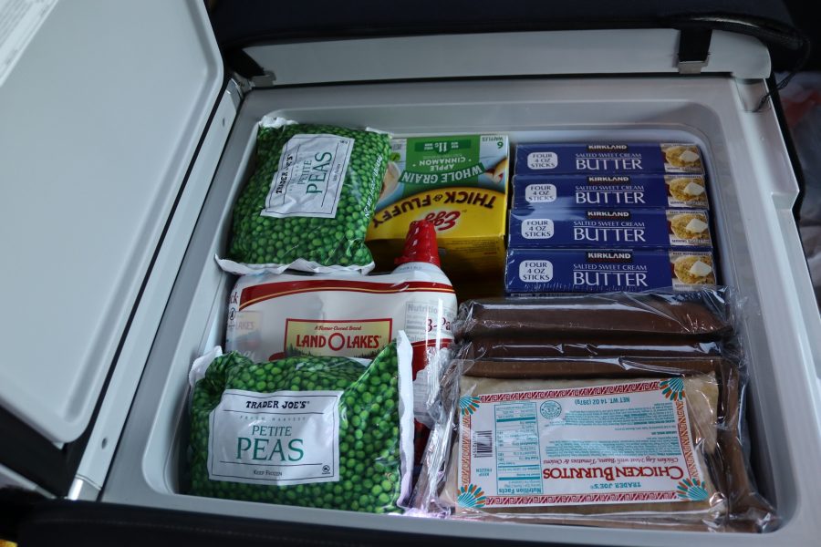 This picture shows various items on top of freezer but many more delicious items are below. Peas, butter and burritos for tribal families.