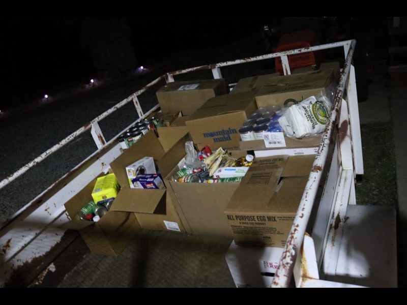 Getting dark a lot earlier so flash was needed to show just how many distributions will be personally delivered by tribe in the following days. Packs of goods for the Miwok Tribe.