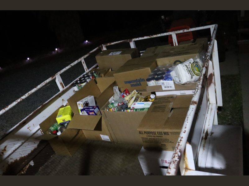 Getting dark a lot earlier so flash was needed to show just how many distributions will be personally delivered by tribe in the following days. Packs of goods for the Miwok Tribe.