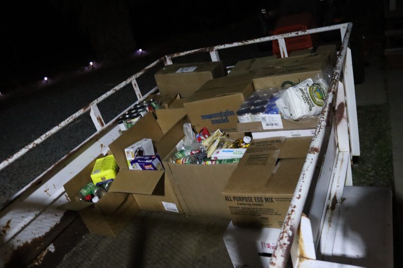 Getting dark a lot earlier so flash was needed to show just how many distributions will be personally delivered by tribe in the following days. Packs of goods for the Miwok Tribe.