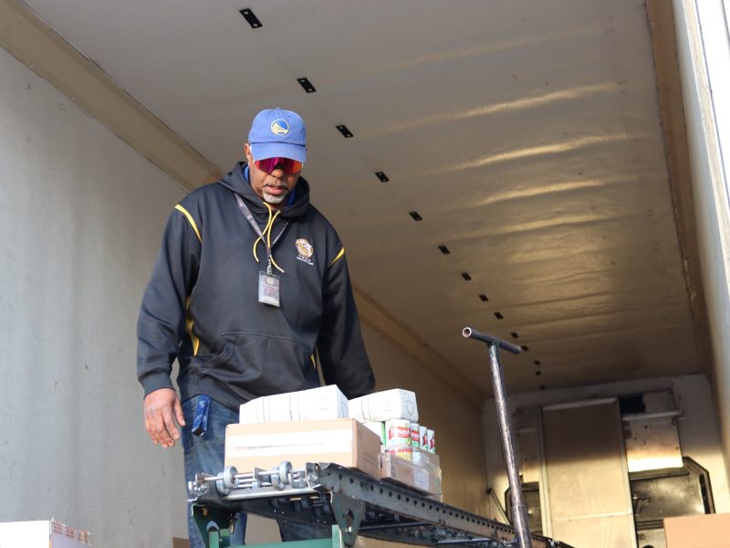 Last part of the last distribution of the day, Specialist Ronald Buckman waits for tribal staff before unloading remaining items. Tule River Specialist Ronald Buckman in truck filled with goods for the December 2023 USDA food distribution.