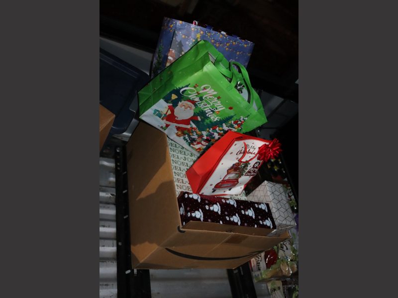 Big box full of present's to overflowing bought and donated as part of event. Various foods to be delivered during December 2023 Food for Tribal Families Program.
