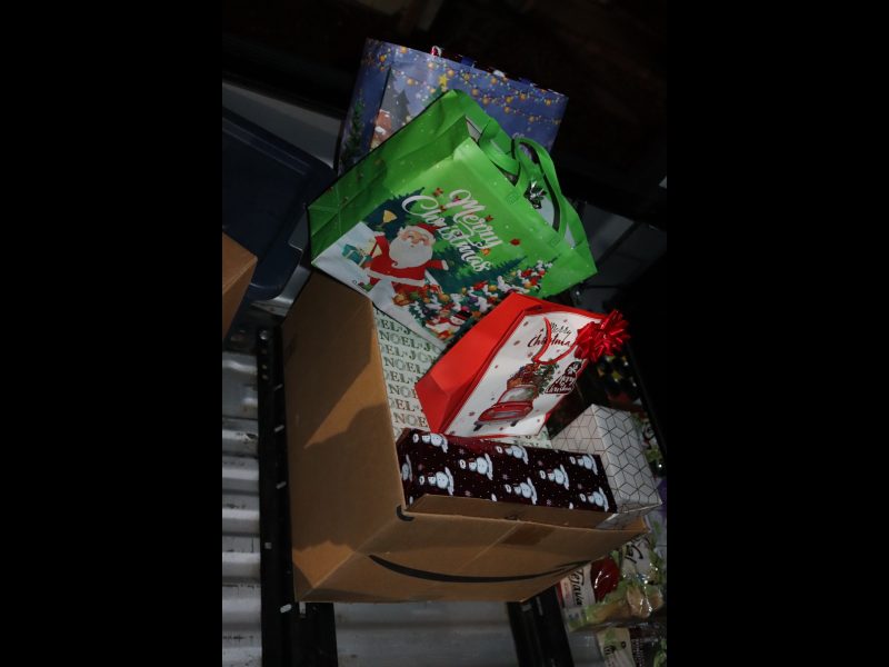 Big box full of present's to overflowing bought and donated as part of event. Various foods to be delivered during December 2023 Food for Tribal Families Program.