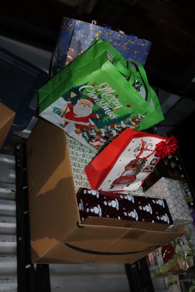 Big box full of present's to overflowing bought and donated as part of event. Various foods to be delivered during December 2023 Food for Tribal Families Program.