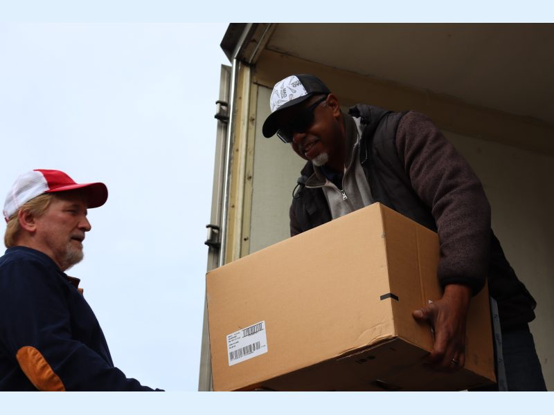To start the day Specialist Ronald Buckman starts the distribution with assistance of tribal staff. Ronald Buckman assists tribal staff member Tiger Paulk to unload some goods.