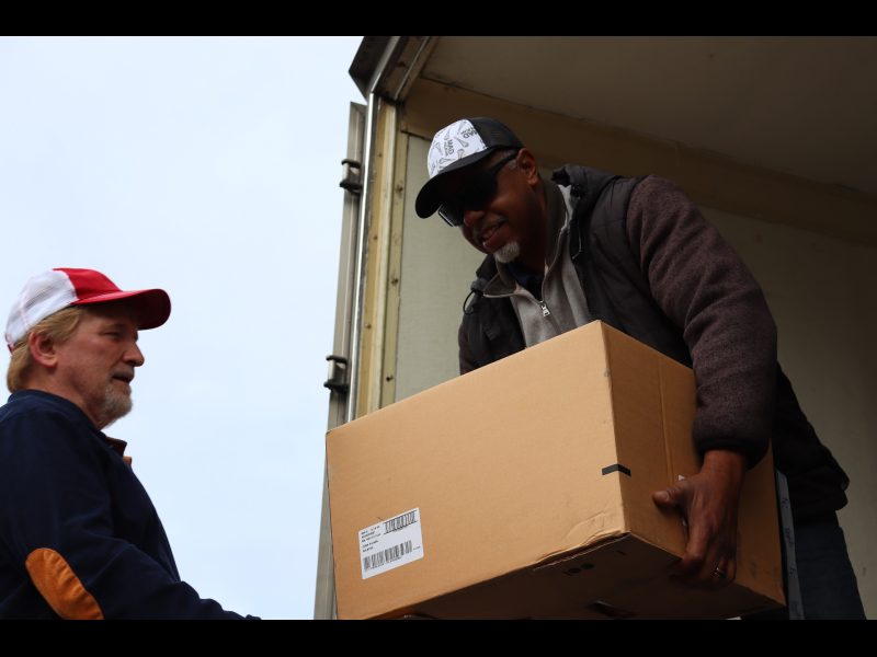 To start the day Specialist Ronald Buckman starts the distribution with assistance of tribal staff. Ronald Buckman assists tribal staff member Tiger Paulk to unload some goods.