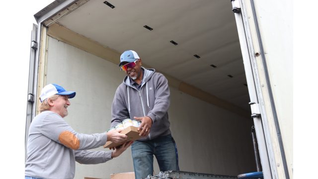 Tiger Paulk and Ronald Buckman helping each other unload goods for the February 2024 USDA Food Distribution.