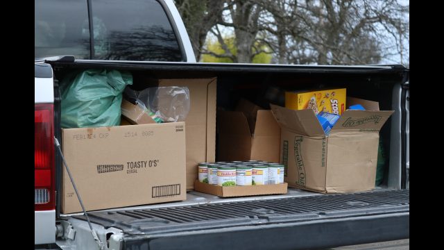Not easy sliding food forward under a truck canopy. If weather persists tribal delivery trailer will receive a custom hinged roof to protect foods during deliveries. Goods to be delivered by the California Valley Miwok Tribe in February 2024.