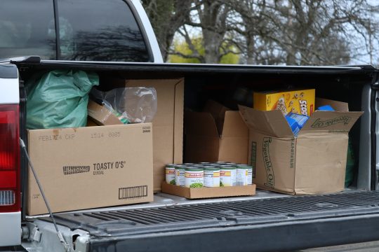 Not easy sliding food forward under a truck canopy. If weather persists tribal delivery trailer will receive a custom hinged roof to protect foods during deliveries. Goods to be delivered by the California Valley Miwok Tribe in February 2024.