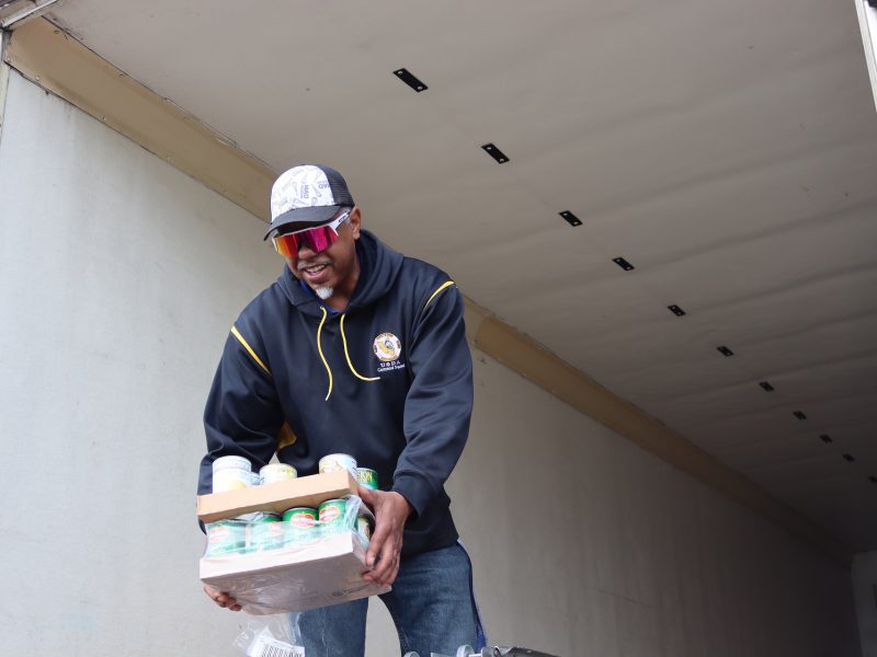 Yet another distribution finishing as Specialist Ronald Buckman hands canned items to tribal staff. Ronald Buckman handing some goods to Tiger Paulk during the March 2024 USDA food distribution.