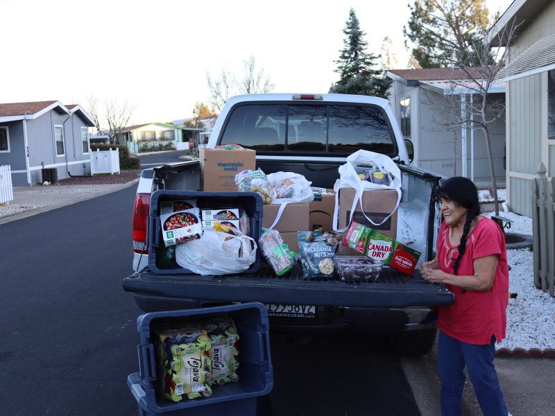 (FFTF) Director Mildred Burley, stands with frozen goods, teas, sodas, snacks, breads and an array of various fruits and berries. Tribal Elder Mildred Burley standing with goods being delivered to her in March 2024.