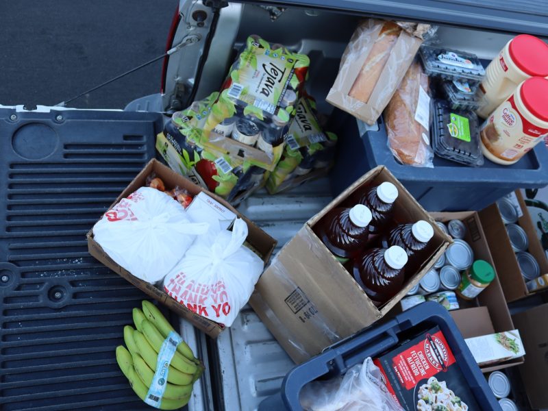 Drinks, fruits, bottom of picture shows tub holding almost 100 pounds of frozen meats and dinners, also large Cantonese take out to celebrate another great distribution.