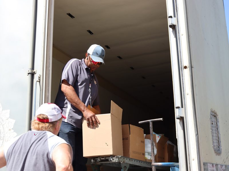 Beginning of a great distribution as Ronald Buckman prepares first item. Ronald Buckman helping tribal staff unloading goods during the May 2024 USDA Food Distribution.