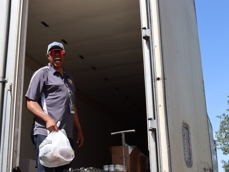During distribution Ronald Buckman having a good time waits for staffer. Ronald Buckman having fun delivering goods during the May 2024 USDA Food Distribution.