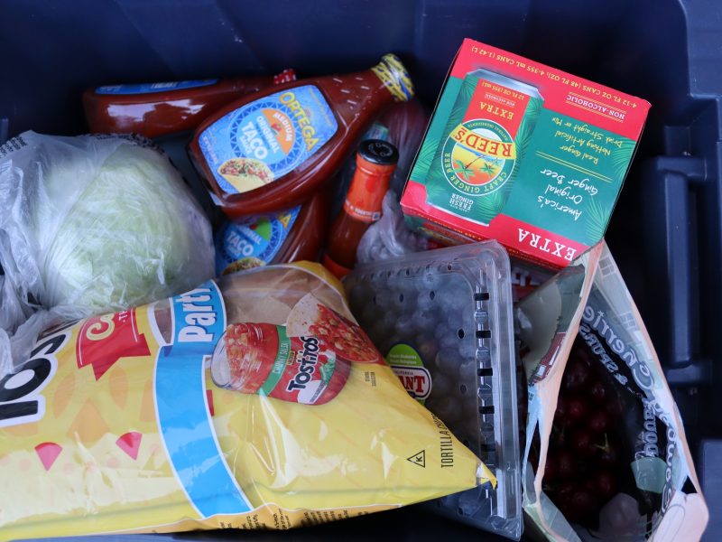 Various condiments, snacks, vegetables, drinks and fruits.