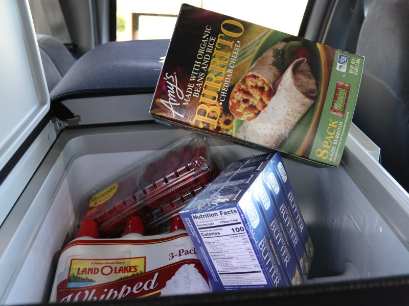 Various dairy, fruits and frozen dinner items.