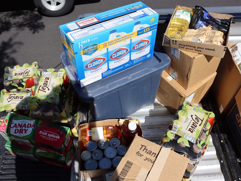 Tub full of breads, multiple teas, sodas, juices, boxed and dry goods.