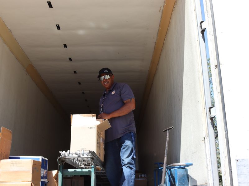 Program provider Ronald Buckman near the end of the day's event. Ronald Buckman helps Tiger Paulk unloading goods during June 2024 USDA Food Distribution.