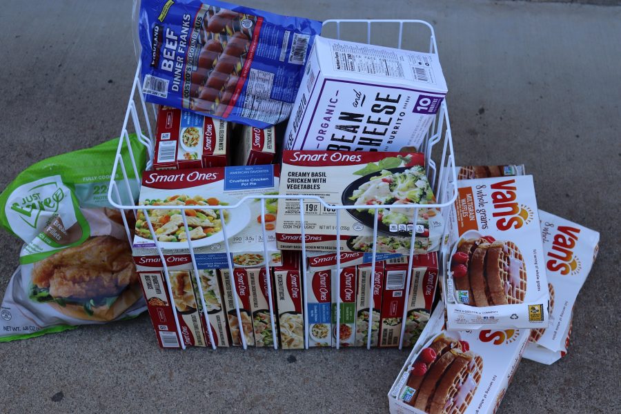Numerous frozen entrees and foods. A basket of food on the ground for the July 2024 Food for Tribal Families Program distribution by the California Valley Miwok tribe.