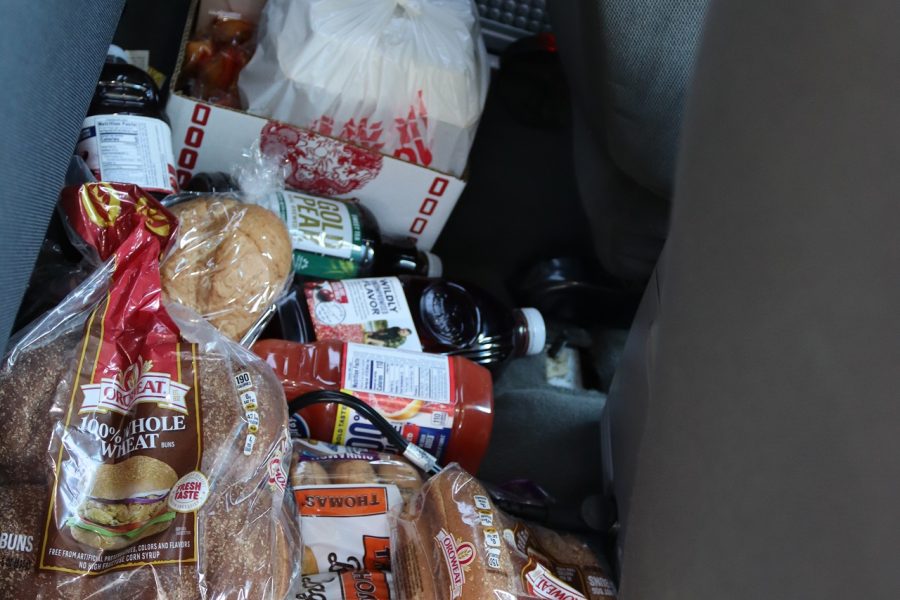 Various breads and juices and large Cantonese take out. Assorted bread and juices in the back of a car at the July 2024 Food for Tribal Families Program distribution by the California Valley Miwok tribe.
