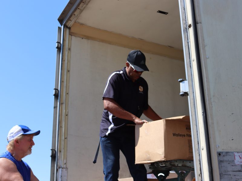 At a point in the distribution very large box of frozen meats. Ronald Buckman helping CVMT staff to unload some goods during the July 2024 USDA food distribution.