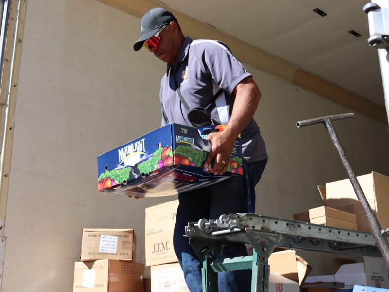 Assistant Director Ronald Buckman bringing up fresh fruit that will be shared amongst the many families.